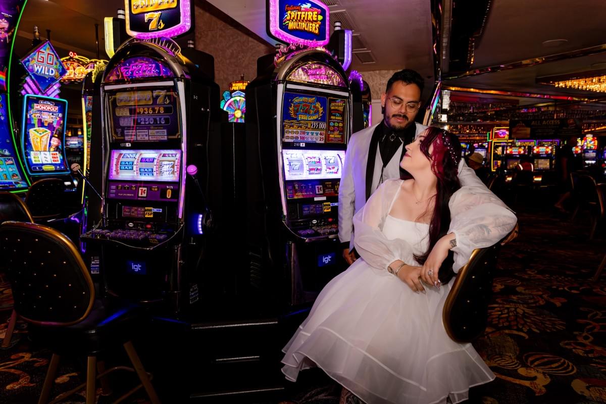 Couple smiling and posing together inside a Las Vegas casino, capturing the vibrant gaming and wedding atmosphere. Couple smiling and posing together inside a Las Vegas casino, capturing the vibrant gaming and wedding atmosphere.
