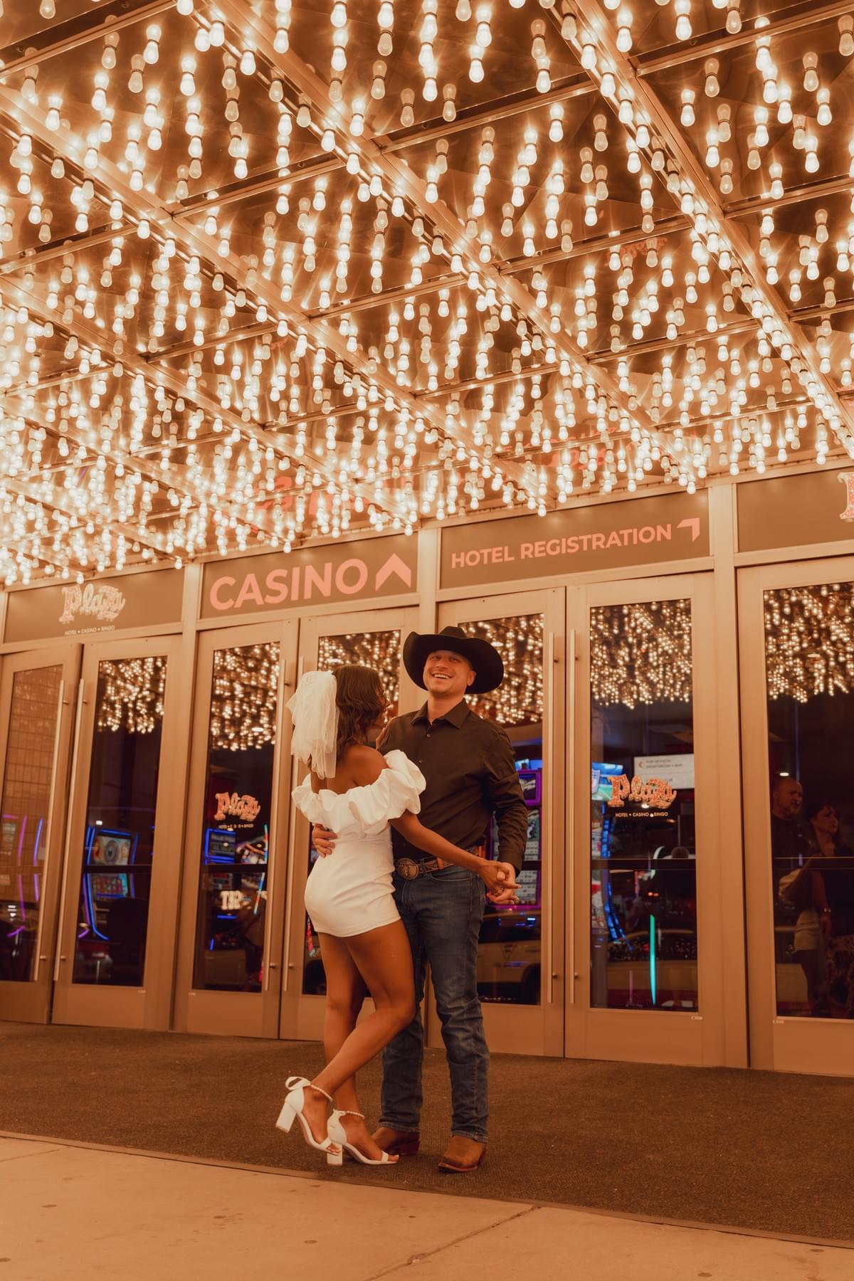 Couple dancing under neon lights on Fremont Street in Las Vegas during their wedding or elopement photo session. Couple dancing under neon lights on Fremont Street in Las Vegas during their wedding or elopement photo session.