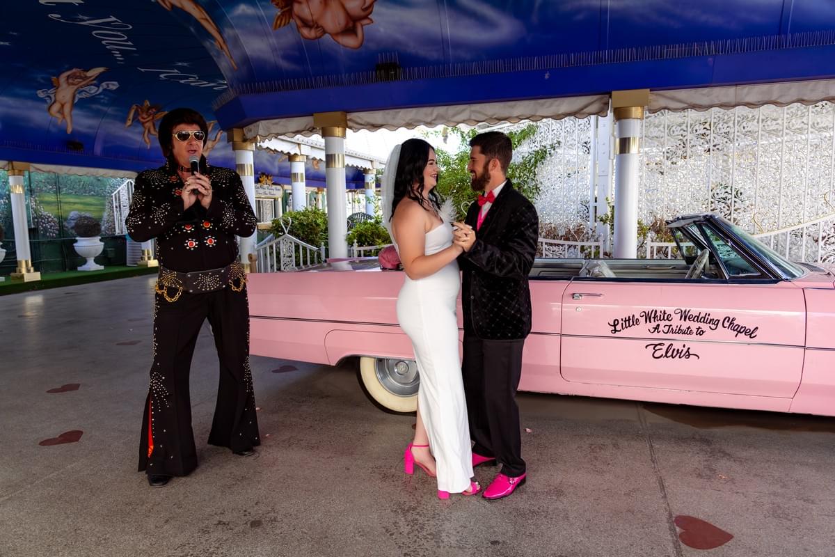 Couple getting married at the Little White Chapel in Las Vegas with Elvis impersonator officiating their ceremony. Couple getting married at the Little White Chapel in Las Vegas with Elvis impersonator officiating their ceremony.