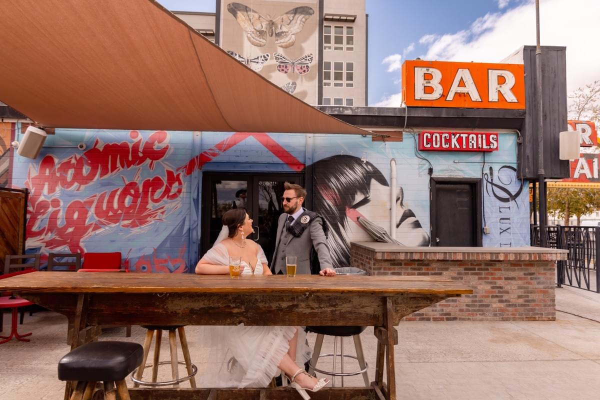 Couple enjoying a photo session outside Atomic Liquors, the iconic Fremont Street bar in Downtown Las Vegas. Couple enjoying a photo session outside Atomic Liquors, the iconic Fremont Street bar in Downtown Las Vegas.