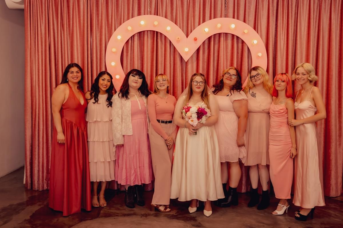 Bride with her bridesmaids posing together outside Sure Thing Chapel in Las Vegas, capturing joyful moments during a wedding celebration. Bride with her bridesmaids posing together outside Sure Thing Chapel in Las Vegas, capturing joyful moments during a wedding celebration.