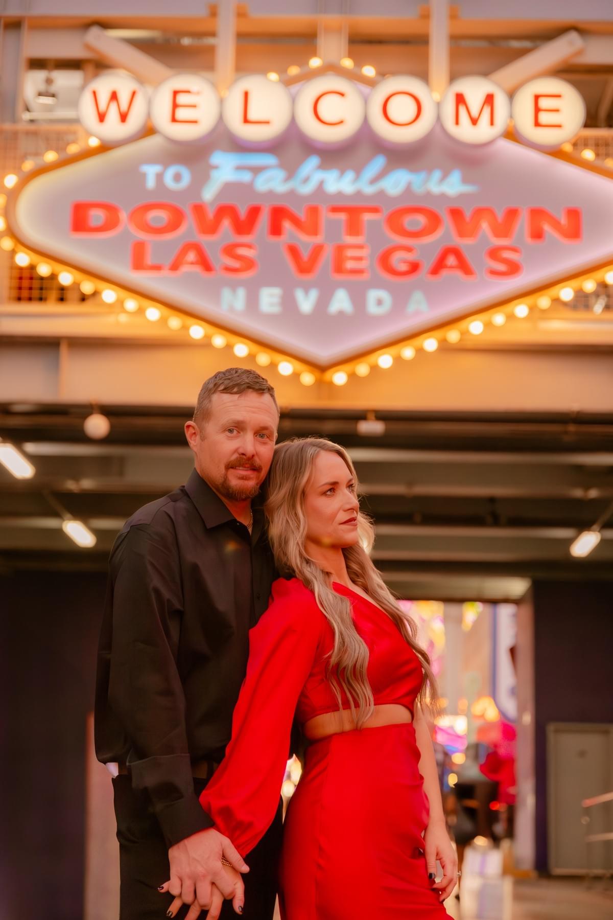 Couple standing in front of the Fremont Street Experience welcome sign, a must-visit Las Vegas photo location. Couple standing in front of the Fremont Street Experience welcome sign, a must-visit Las Vegas photo location.