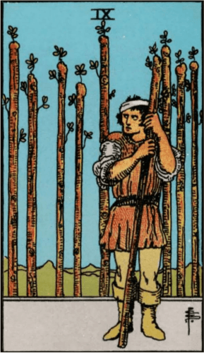 A battered warrior with a bandaged head leans on a staff. 8 staffs are behind like a fence A battered warrior with a bandaged head leans on a staff. 8 staffs are behind like a fence