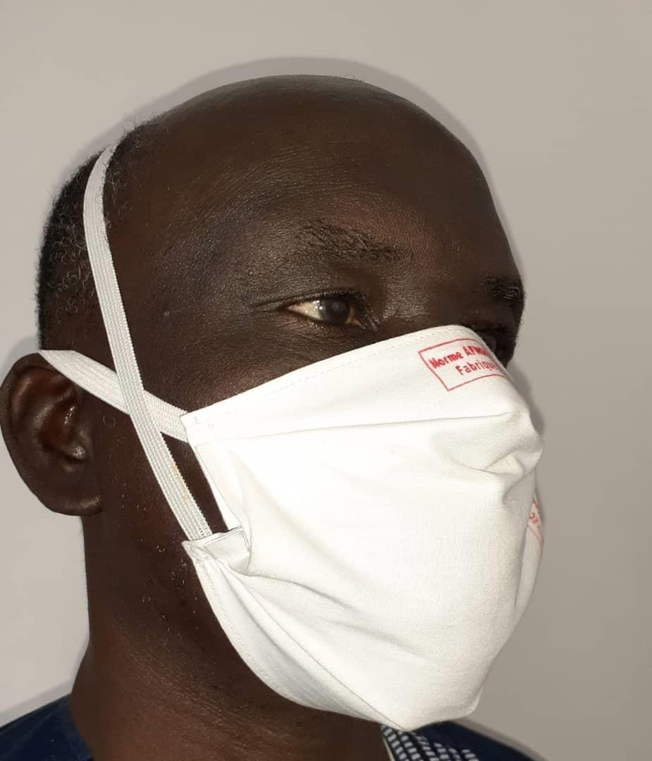 Sanoussi Diakite wearing the barrier face mask produced by the women he trained in Kolda, Senegal Sanoussi Diakite wearing the barrier face mask produced by the women he trained in Kolda, Senegal