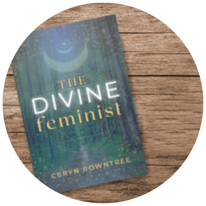 The cover of Ceryn Rowntree's book, The Divine Feminist. The cover shows a forest scene with golden stars and Ceryn Rowntree's logo imposed over it. In the centre of the page are the words "The Divine Feminist" in yellow and white text, while Ceryn's name is at the bottom of the page in yellow. The book rests upon a wooden surface. The cover of Ceryn Rowntree's book, The Divine Feminist. The cover shows a forest scene with golden stars and Ceryn Rowntree's logo imposed over it. In the centre of the page are the words "The Divine Feminist" in yellow and white text, while Ceryn's name is at the bottom of the page in yellow. The book rests upon a wooden surface.