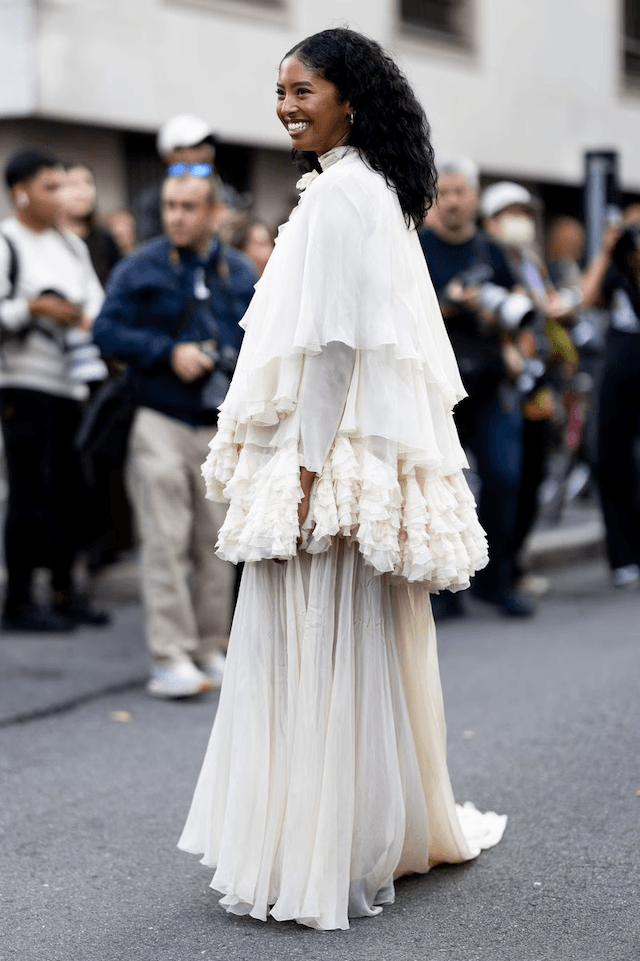 Natalia paired the ensemble with a structured black handbag, black footwear just peeking beneath the gown, and subtle gold jewelry Natalia paired the ensemble with a structured black handbag, black footwear just peeking beneath the gown, and subtle gold jewelry