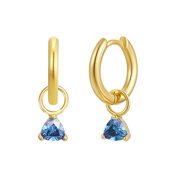 old Trip recently started making birthstone jewelry, like these December charms ($33 each) with blue topaz–colored CZ, shown on huggie hoop earrings ($47 per pair). old Trip recently started making birthstone jewelry, like these December charms ($33 each) with blue topaz–colored CZ, shown on huggie hoop earrings ($47 per pair).