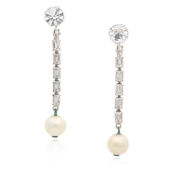 Jacqueline Kennedy’s earclips with simulated diamond–set chains and simulated pearl drops, estimate $13,000–$20,000 Jacqueline Kennedy’s earclips with simulated diamond–set chains and simulated pearl drops, estimate $13,000–$20,000