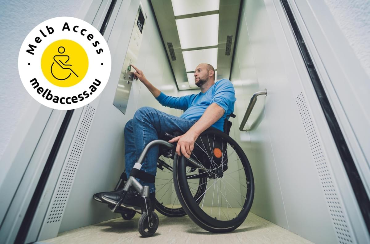 Person with a physical disability who uses wheelchair using lift in building with logo Person with a physical disability who uses wheelchair using lift in building with logo