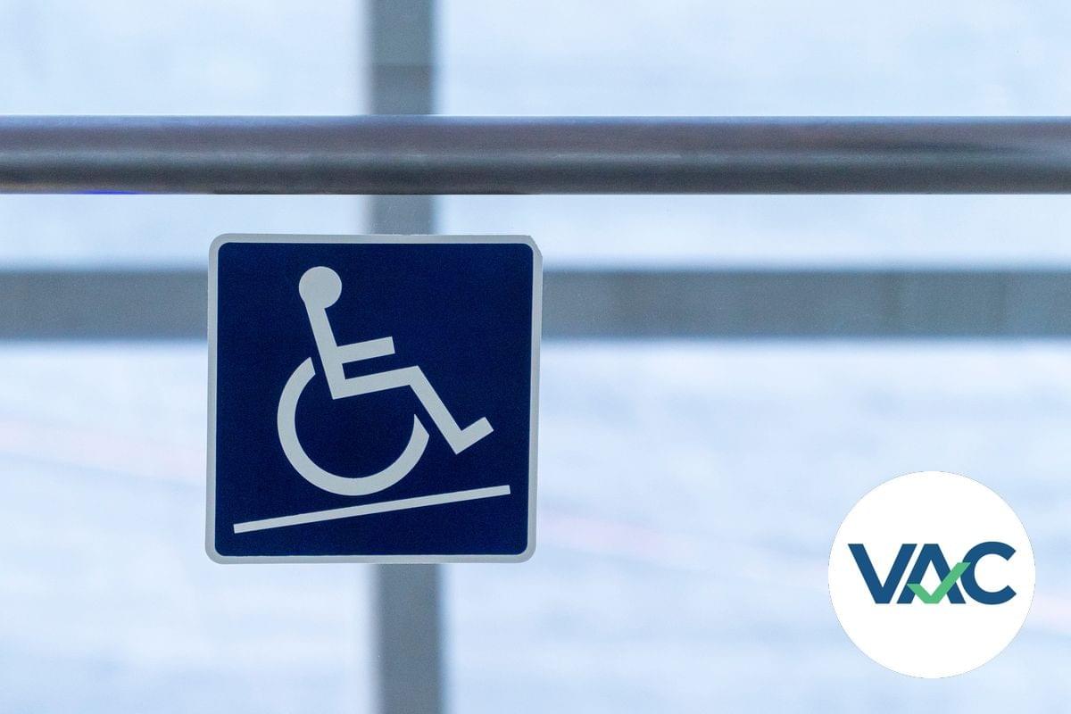 A detail of a ramp sign whowing a wheelchair symbol on an angle moving up a sloped path (represented by an angled line) A detail of a ramp sign whowing a wheelchair symbol on an angle moving up a sloped path (represented by an angled line)