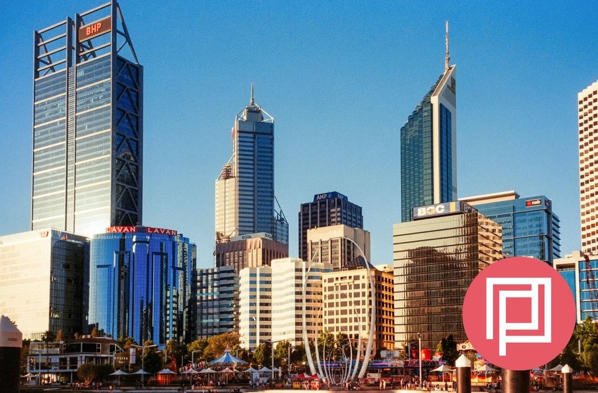 Two architects are working on marking up a drawing on a desk Two architects are working on marking up a drawing on a desk