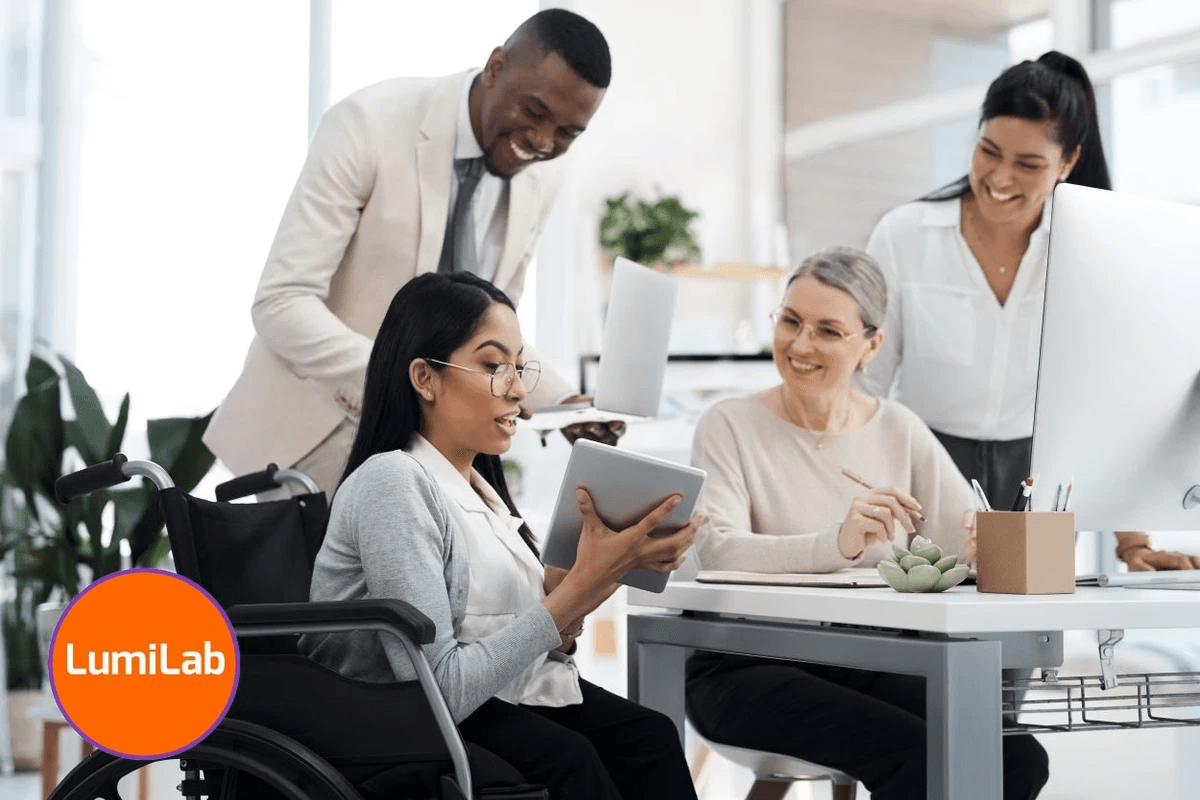 A diverse group of four colleagues, including a woman in a wheelchair holding a tablet, collaborates in an office. A diverse group of four colleagues, including a woman in a wheelchair holding a tablet, collaborates in an office.