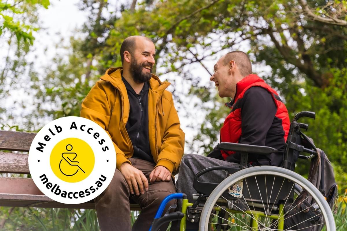 Portrait of a paralyzed young man in a wheelchair with a friend on a bench in a public park in the city, talking and laughing with logo Portrait of a paralyzed young man in a wheelchair with a friend on a bench in a public park in the city, talking and laughing with logo