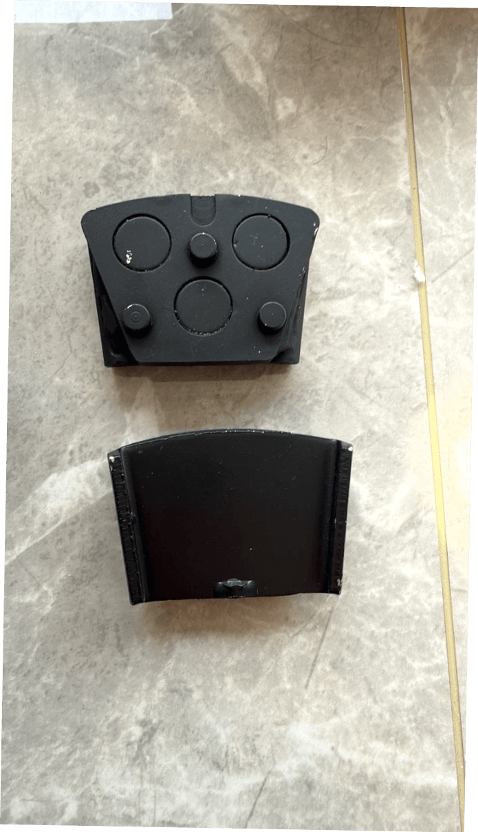 Black HTC-to-trapezoid magnetic adapter pieces showing circular inserts, locator pins and the opposite connection face. Black HTC-to-trapezoid magnetic adapter pieces showing circular inserts, locator pins and the opposite connection face.