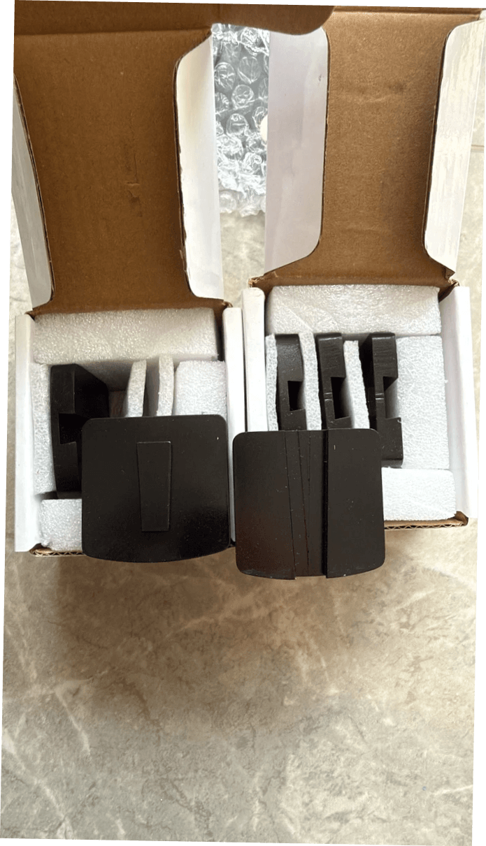 Black Scanmaskin-to-Husqvarna Redi Lock adapter plates displayed in open foam-lined boxes before shipment. Black Scanmaskin-to-Husqvarna Redi Lock adapter plates displayed in open foam-lined boxes before shipment.