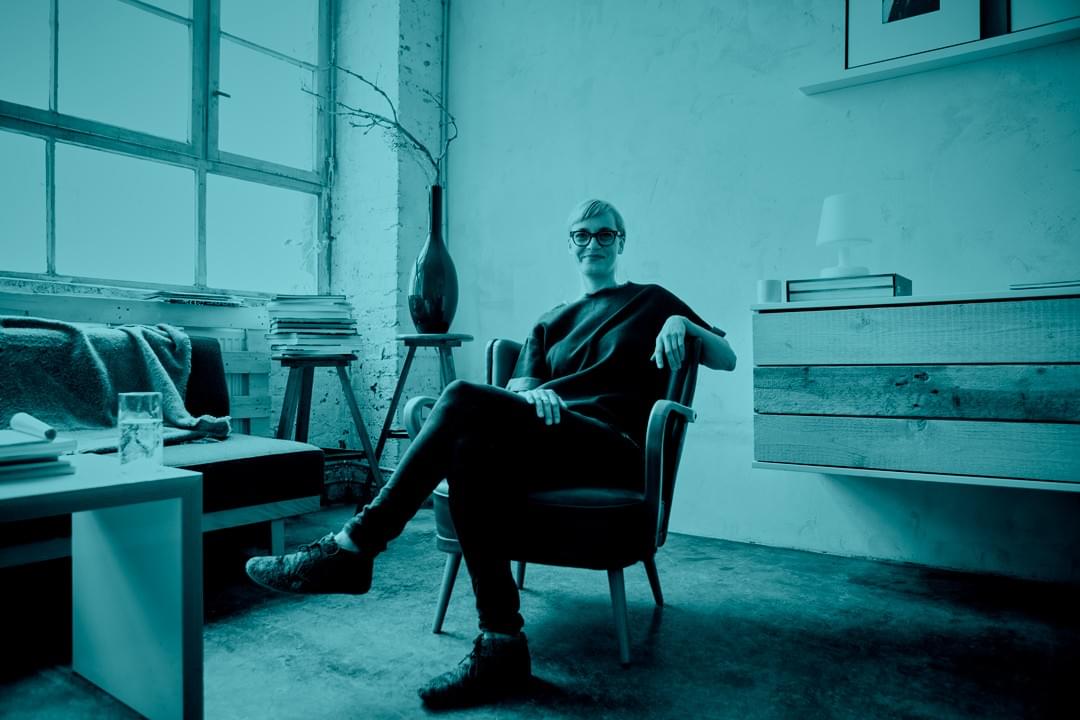 Interior stylist placing curated artwork and decor in a staged residential space  Interior stylist placing curated artwork and decor in a staged residential space