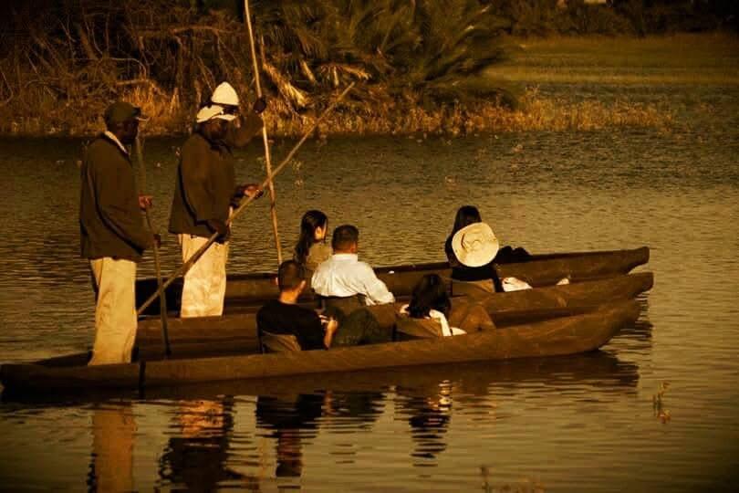 Tourists enjoying a traditional mokoro ride through the tranquil waters of the Okavango Delta. Tourists enjoying a traditional mokoro ride through the tranquil waters of the Okavango Delta.