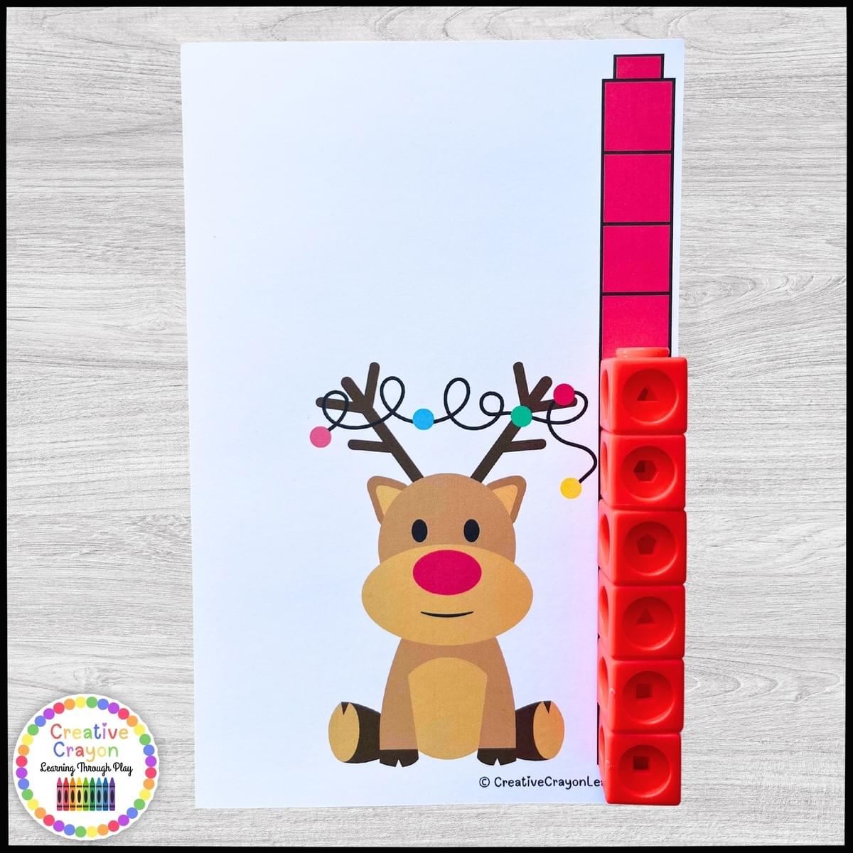 Kindergarten students measuring holiday items with math link cubes in a Christmas-themed center Kindergarten students measuring holiday items with math link cubes in a Christmas-themed center