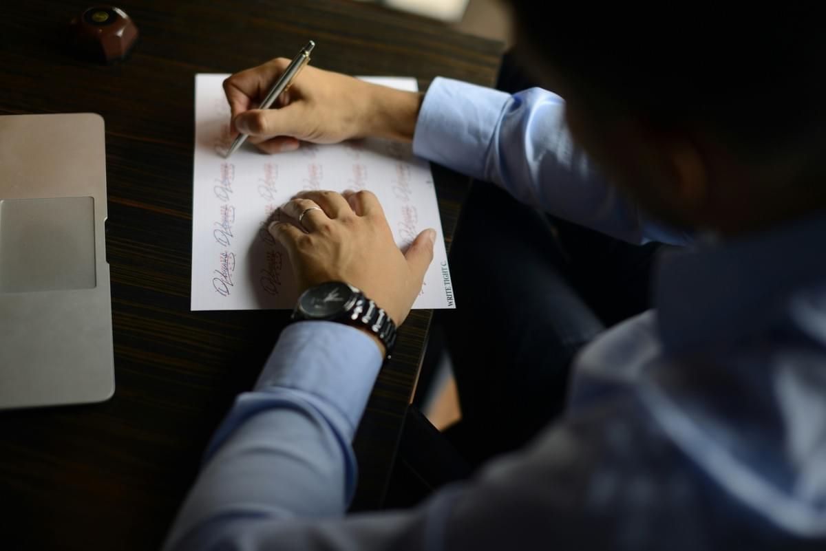 Businessperson reviewing documents at a desk Businessperson reviewing documents at a desk