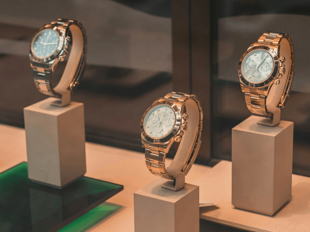 Three wristwatches displayed on stands Three wristwatches displayed on stands