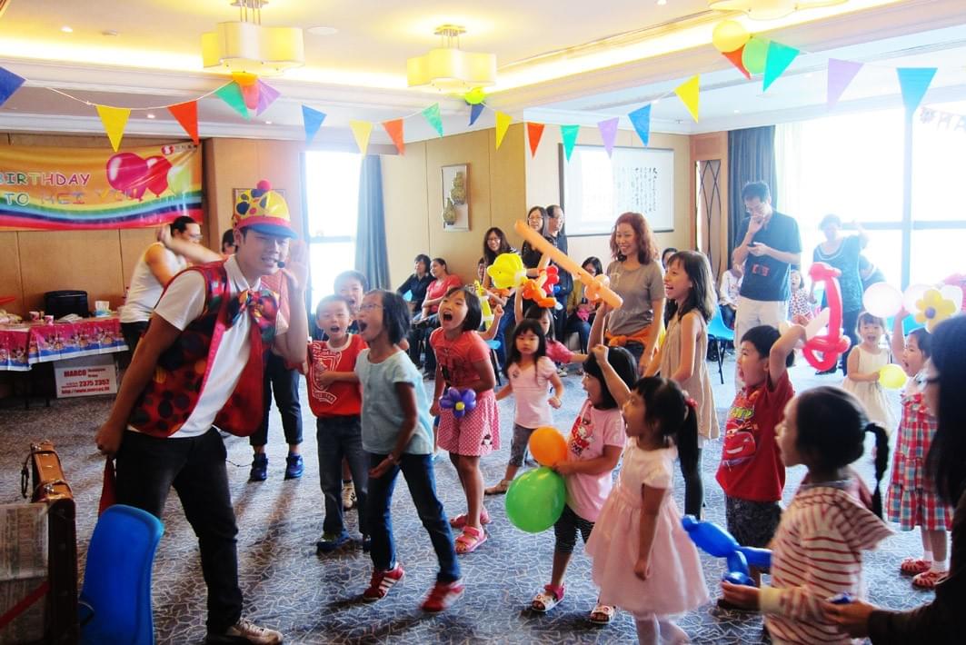 kids having fun and interacting with magician at birthday party kids having fun and interacting with magician at birthday party