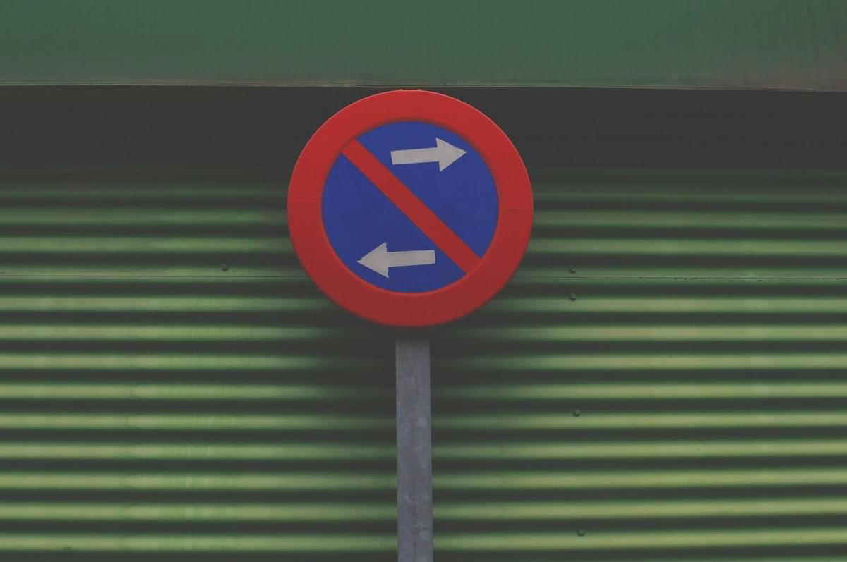 A photo of a round street sign showing one arrow going left and one arrow going right, as shown in the "What, Me Worry?" blog post from The Purple Dog Vegan A photo of a round street sign showing one arrow going left and one arrow going right, as shown in the "What, Me Worry?" blog post from The Purple Dog Vegan
