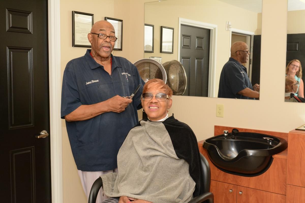 Man styling a woman's hair at a salon Man styling a woman's hair at a salon