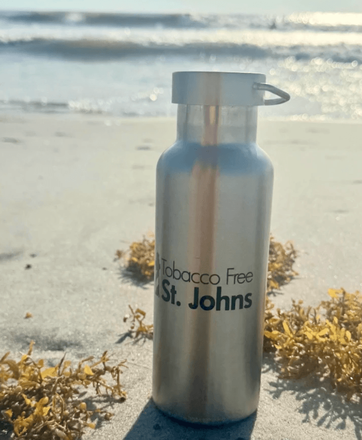 A tobacco free Saint Johns waterbottle on the beach A tobacco free Saint Johns waterbottle on the beach