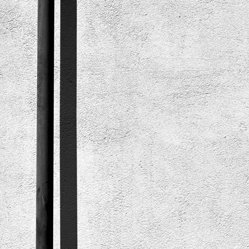 A black and white retaining wall with a pipe installation outside A black and white retaining wall with a pipe installation outside
