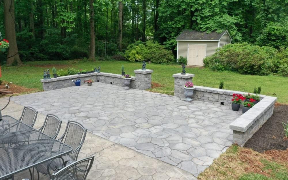 backyard stamped concrete patio addition with stone wall matching existing flatwork backyard stamped concrete patio addition with stone wall matching existing flatwork
