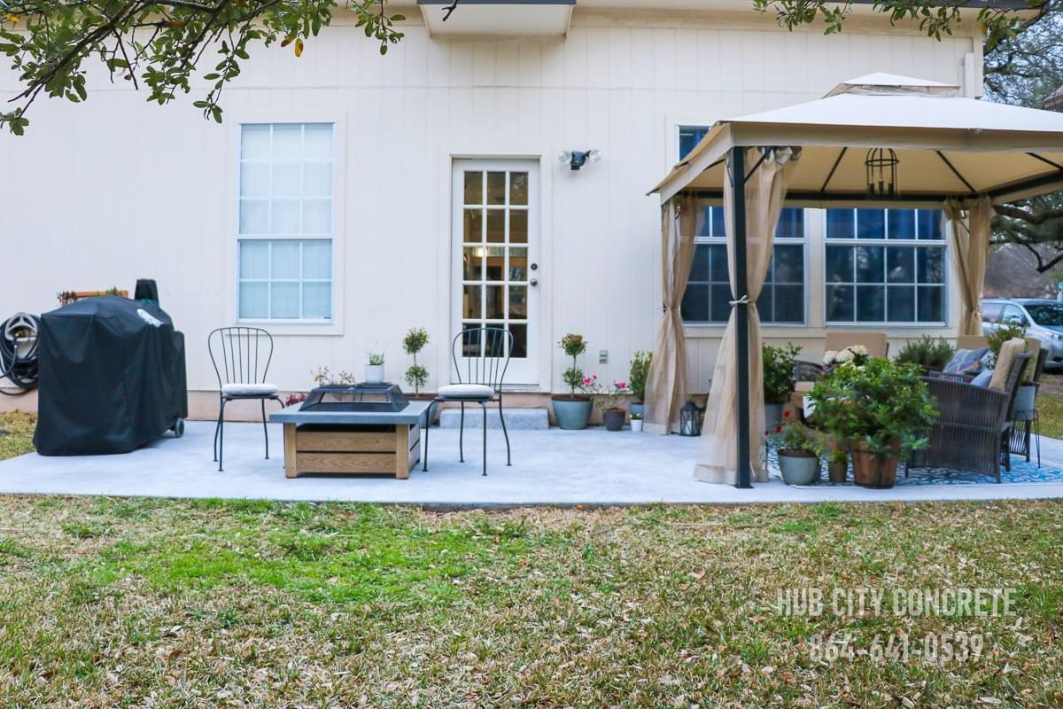 backyard concrete patio with firepit grill and awning with outdoor seating backyard concrete patio with firepit grill and awning with outdoor seating