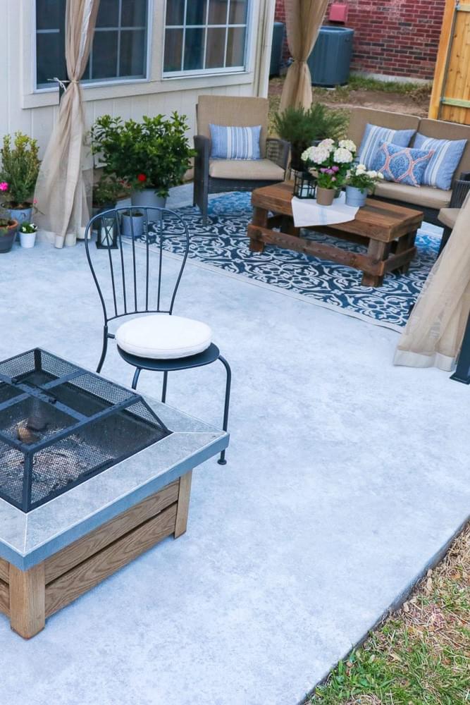 concrete patio with light grey coating and fire pit with outdoor seating under canopy concrete patio with light grey coating and fire pit with outdoor seating under canopy