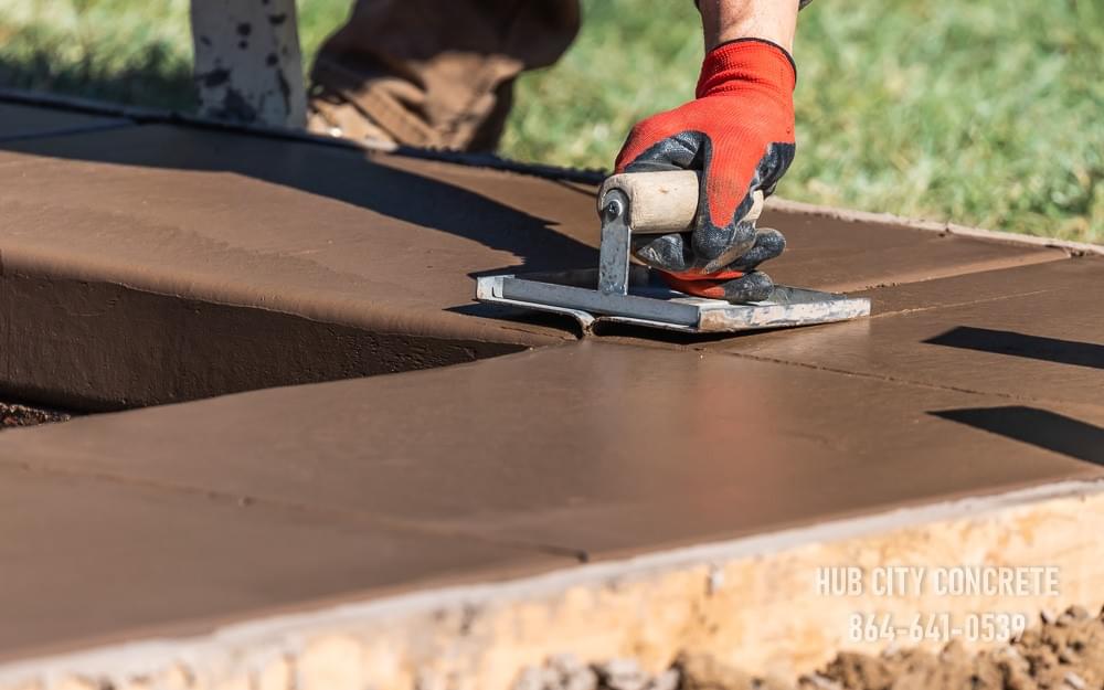 tinted brown concrete wet and adding control joint by hand tool tinted brown concrete wet and adding control joint by hand tool