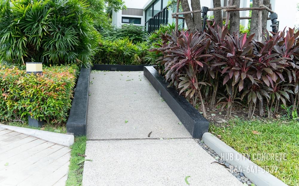 handicap accessible concrete ramp path leading through landscaping plants handicap accessible concrete ramp path leading through landscaping plants