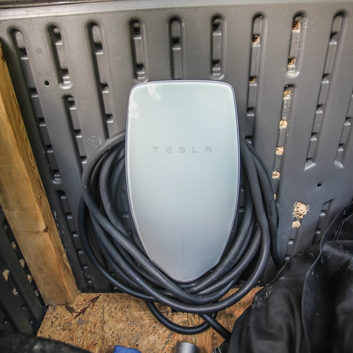 Residential EV Charger In Garage Plugged Up To Car Residential EV Charger In Garage Plugged Up To Car