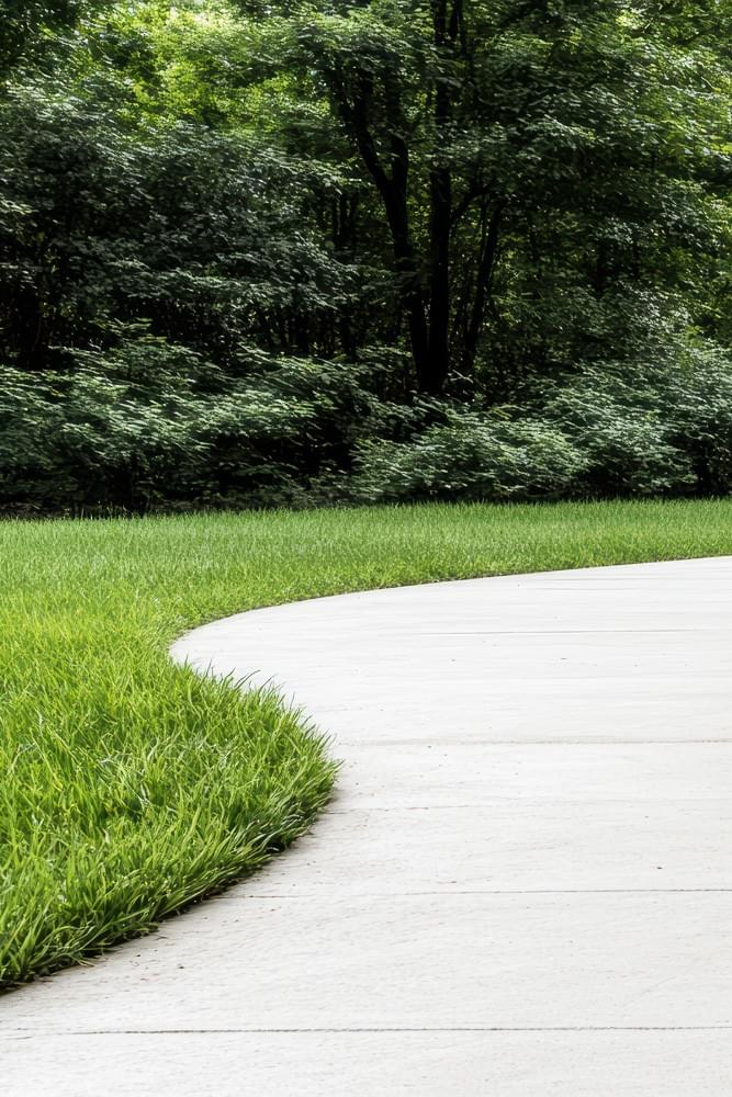 curving concrete path project through green lawn in Spartanburg SC curving concrete path project through green lawn in Spartanburg SC