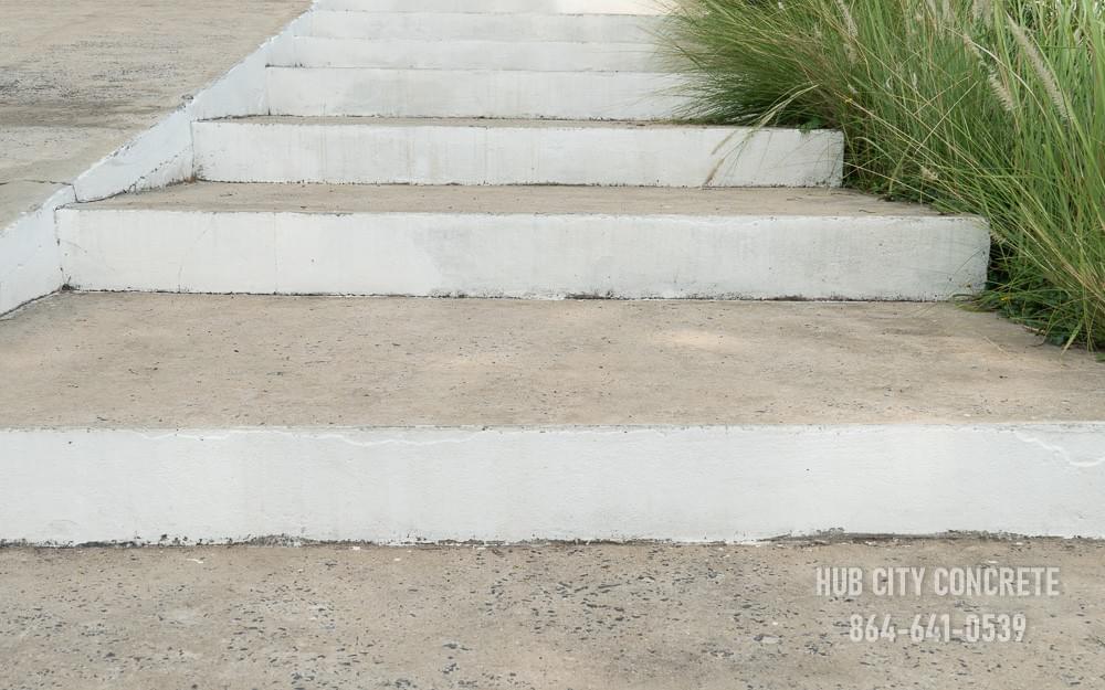 Concrete steps with painted edge along landscaping Concrete steps with painted edge along landscaping