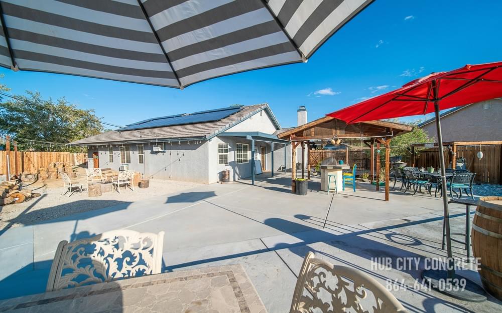 large concrete patio with umbrellas and covered pavilion connected to home large concrete patio with umbrellas and covered pavilion connected to home