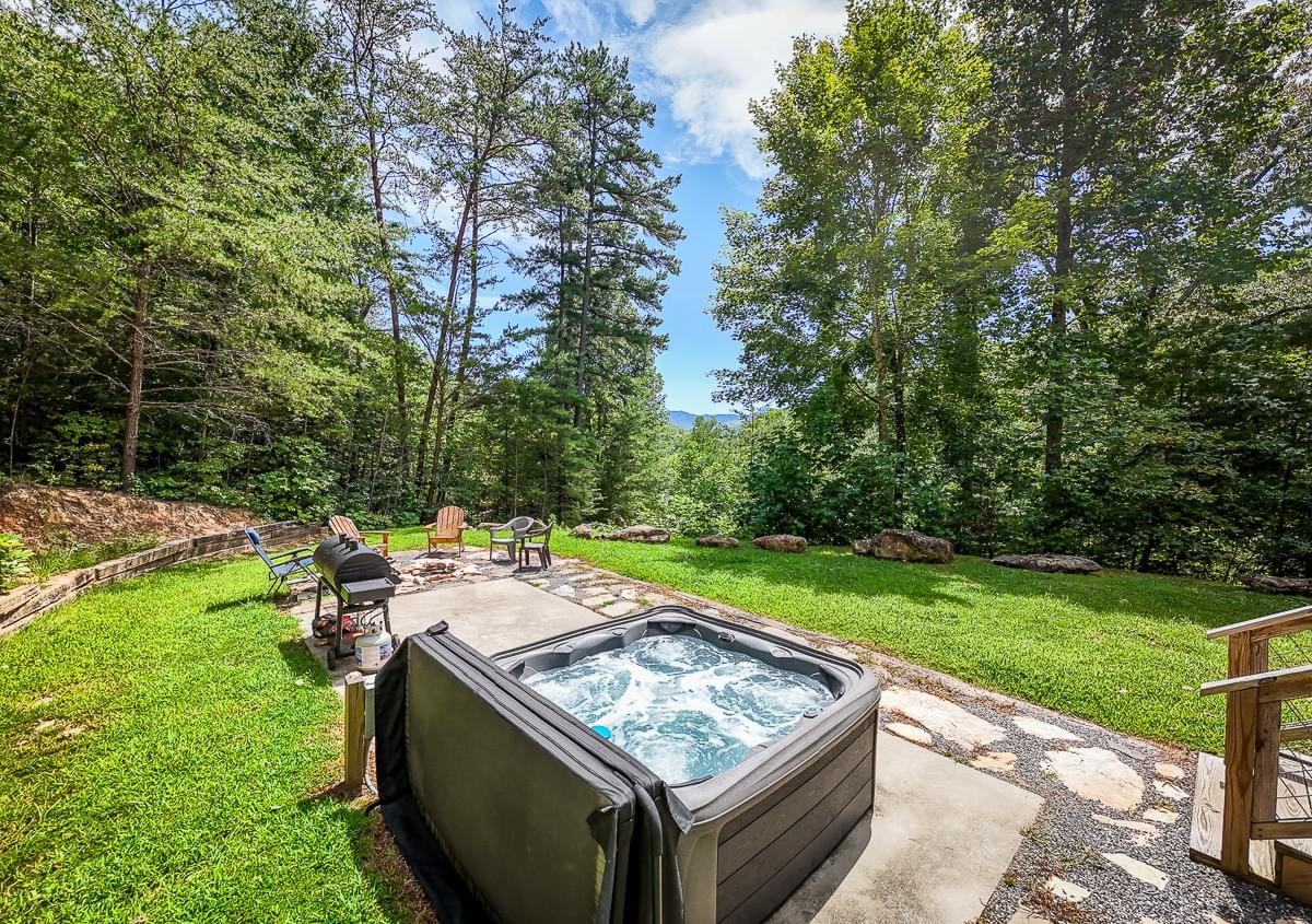 Hot Tub on backyard concrete slab with grill and firepit Hot Tub on backyard concrete slab with grill and firepit