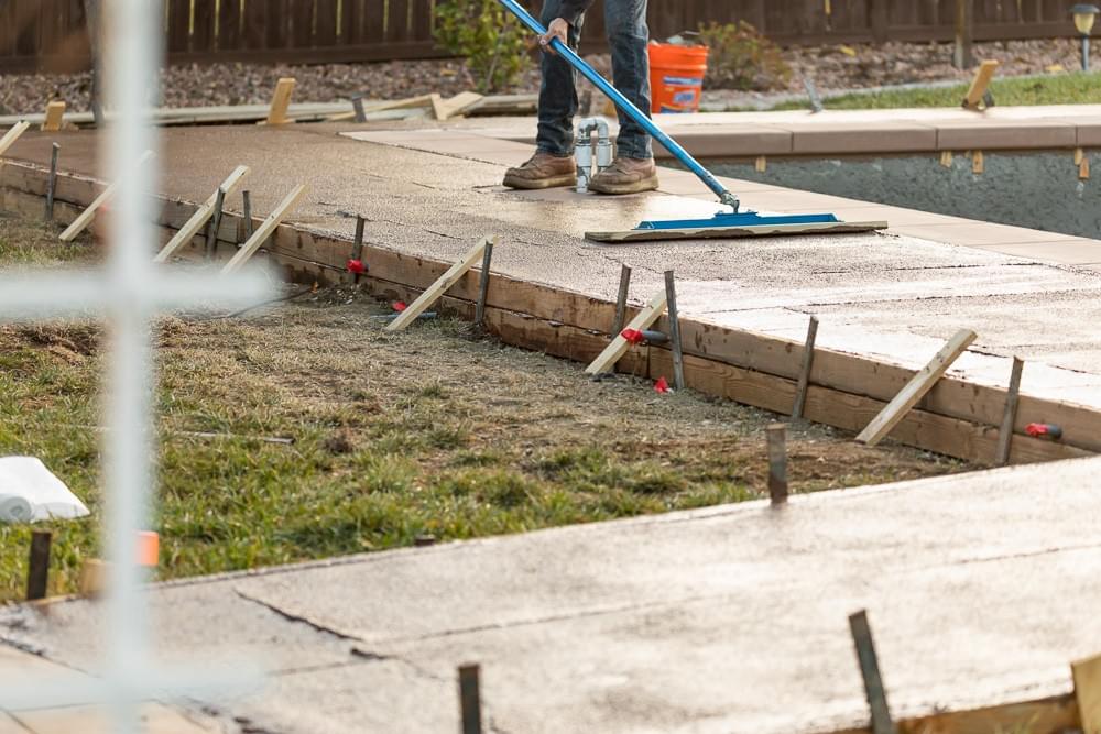 smoothing concrete walkway around pool with tool smoothing concrete walkway around pool with tool