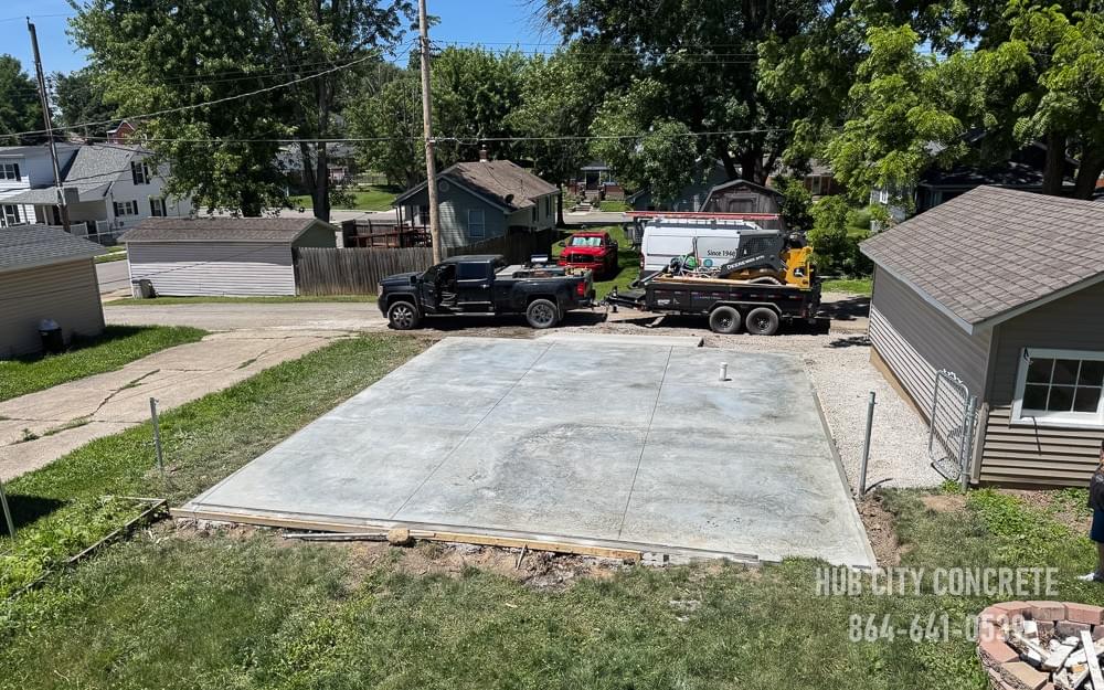 aerial view of latest residential concrete slab worksite with truck and skidsteer aerial view of latest residential concrete slab worksite with truck and skidsteer