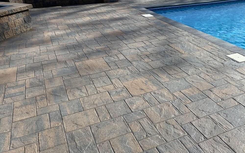 grey and tan stamped concrete pattern by pool to mimick pavers grey and tan stamped concrete pattern by pool to mimick pavers