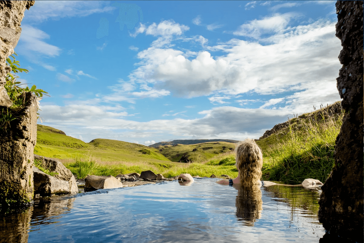 Solo traveller enjoying geothermal bath surrounded by nature Solo traveller enjoying geothermal bath surrounded by nature