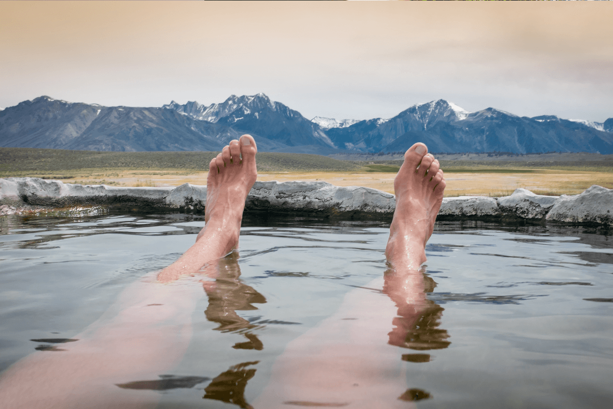 Solo traveller enjoying geothermal bath surrounded by nature Solo traveller enjoying geothermal bath surrounded by nature
