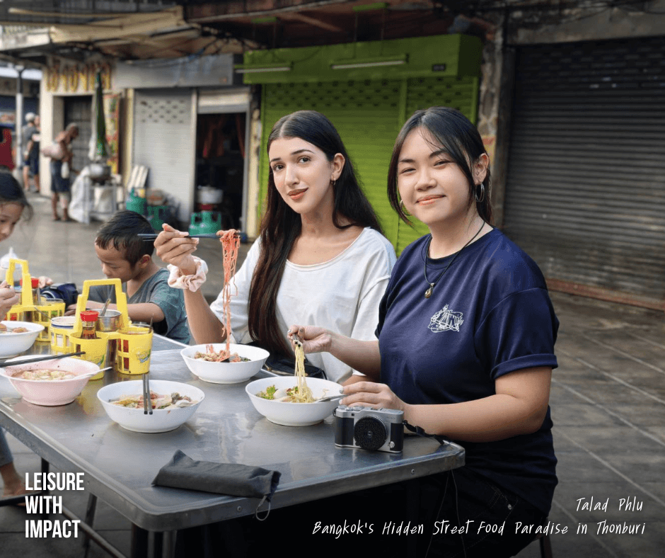 Travelers enjoying local noodle street food in Talad Phlu Bangkok Travelers enjoying local noodle street food in Talad Phlu Bangkok