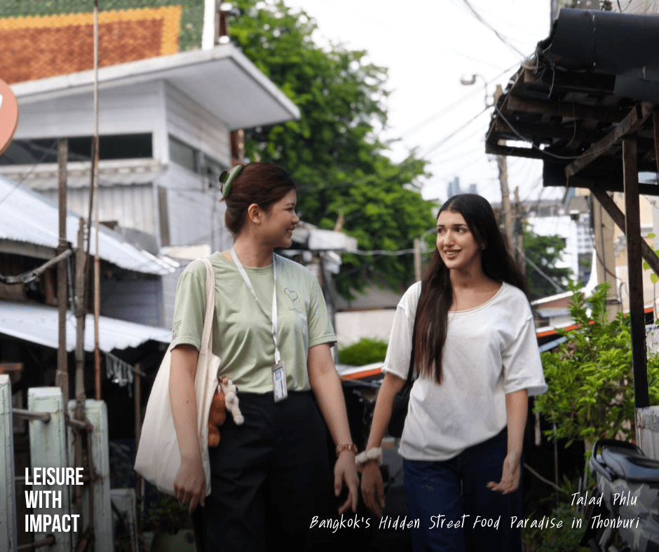 Traveler and local guide walking through Talad Phlu community in Bangkok Traveler and local guide walking through Talad Phlu community in Bangkok