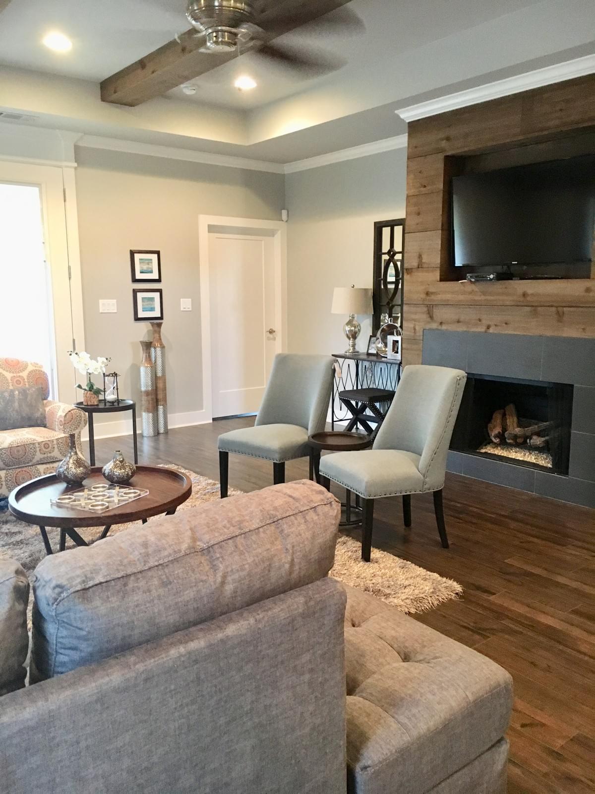 Farmhouse living room featuring neutral color palette and cozy furnishings. Farmhouse living room featuring neutral color palette and cozy furnishings.