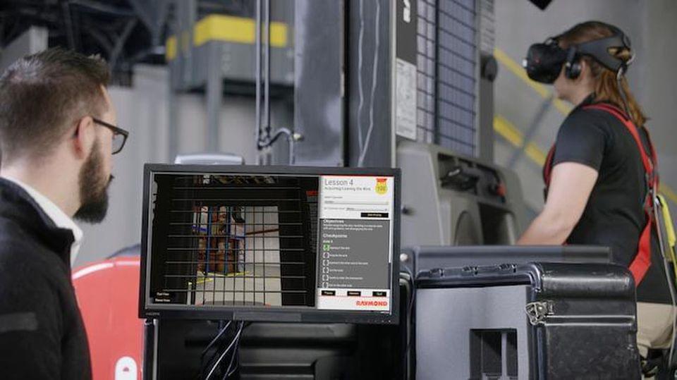 An instructor monitors a forklift operations trainee as they practice operating a Raymond forklift. RAYMOND CORP. An instructor monitors a forklift operations trainee as they practice operating a Raymond forklift. RAYMOND CORP.