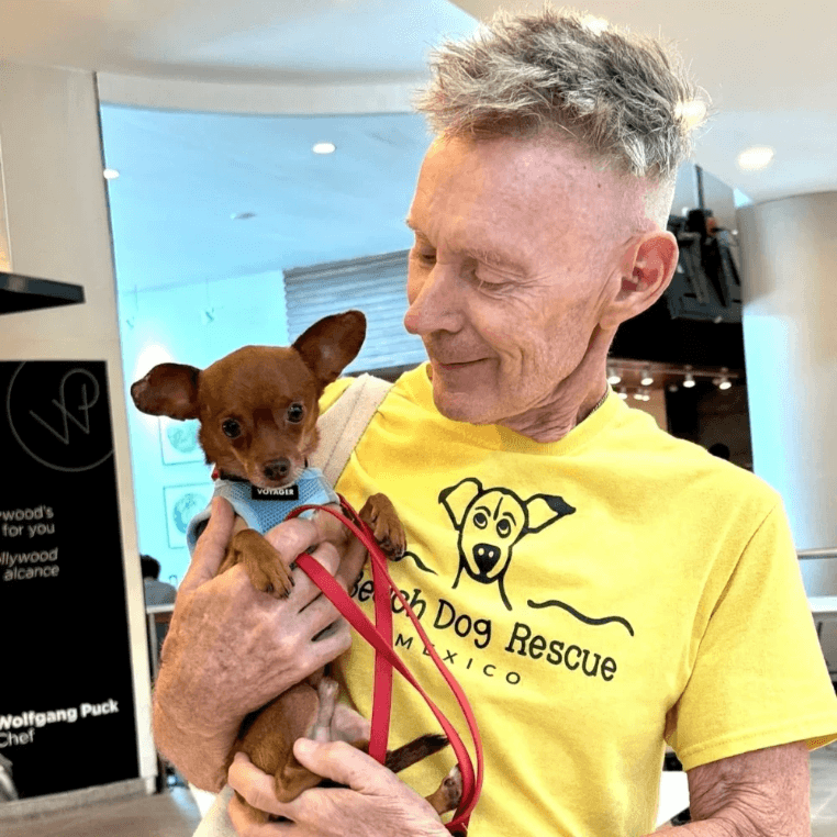 Beach Dog Rescue founder holding a rescued puppy before adoption. Beach Dog Rescue founder holding a rescued puppy before adoption.