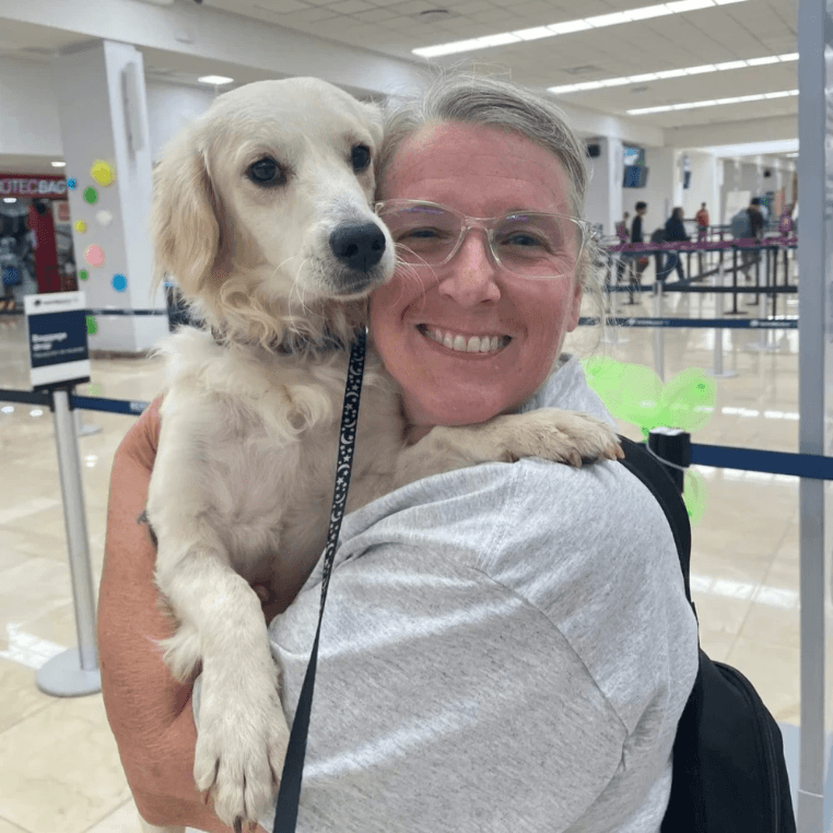 Woman holding a dog at the airport before travel. Woman holding a dog at the airport before travel.